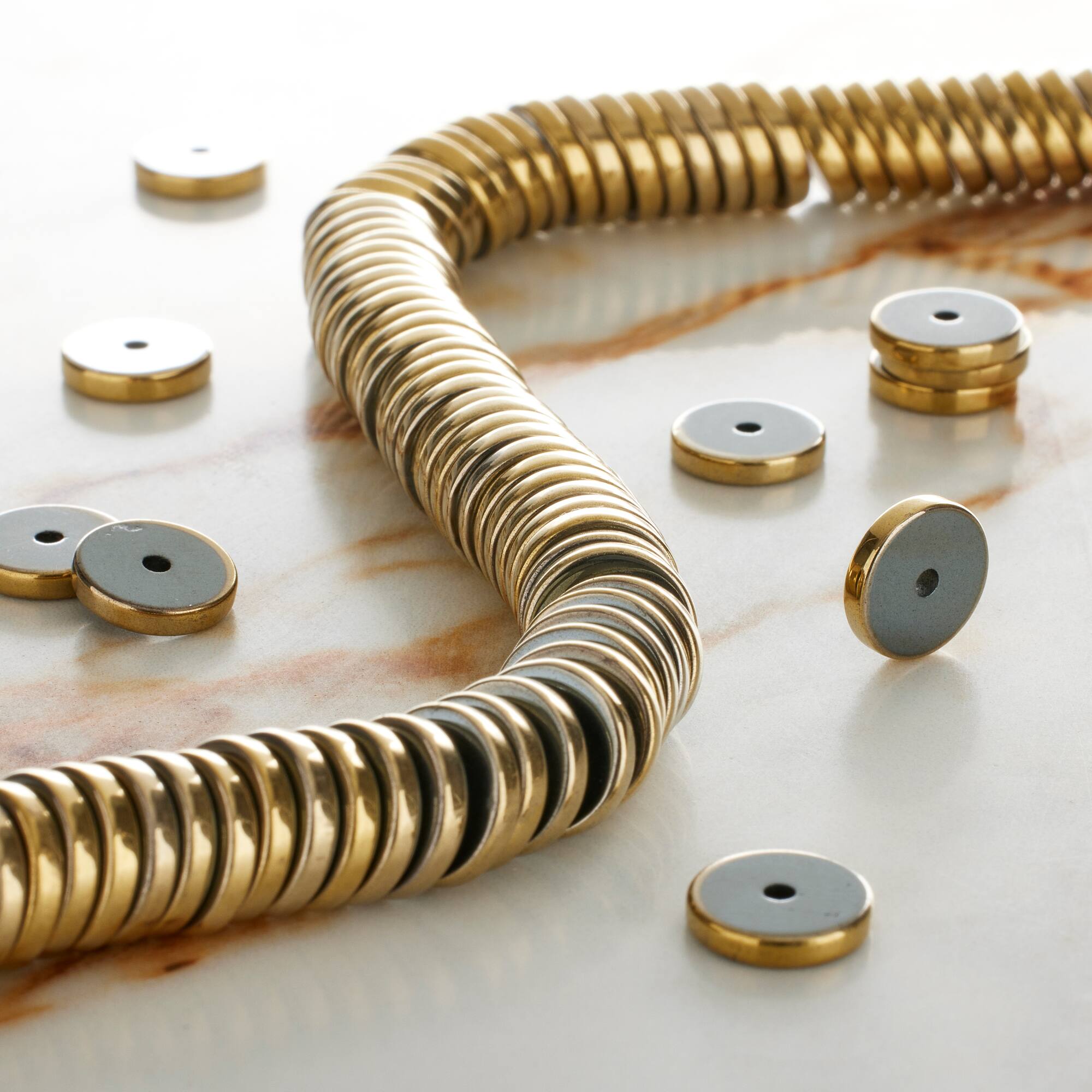 12 Pack: Gold Hematite Heishi Beads by Bead Landing